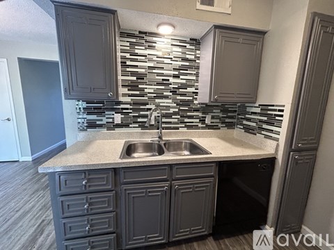 A kitchen with a sink and cabinets.