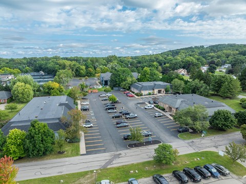A parking lot with cars and a building in the background.