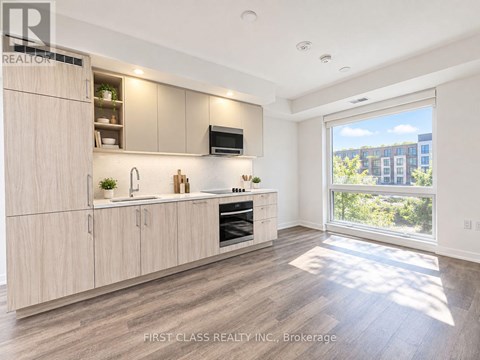 A modern kitchen with wooden cabinets and a large window.