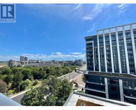A view from a high-rise building looking out over a cityscape with a clear blue sky.