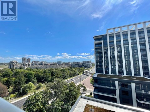 A view from a high-rise building looking out over a cityscape with a clear blue sky.