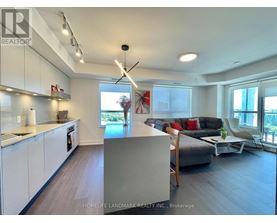 A modern kitchen with white cabinets and a large island.