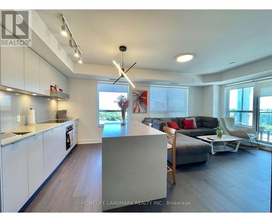A modern kitchen with white cabinets and a large island.