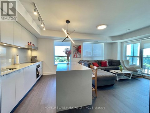 A modern kitchen with white cabinets and a large island.