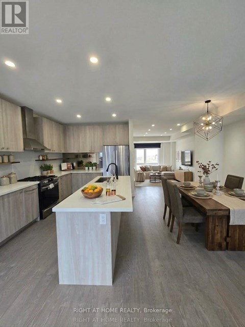 A modern kitchen with a dining area in the background.