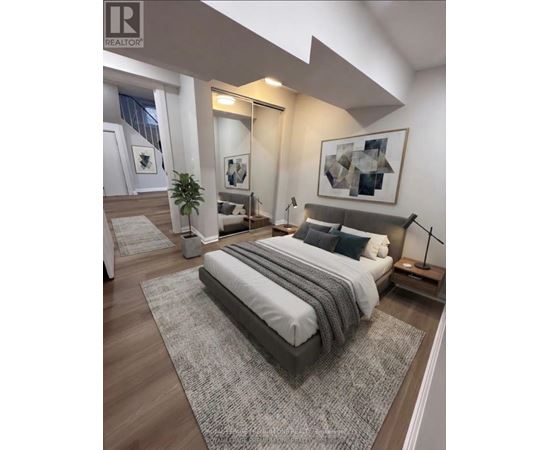 A bedroom with a large bed and a plant.