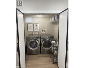 A laundry room with two front loading washing machines.