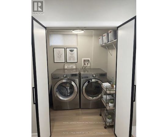 A laundry room with two front loading washing machines.