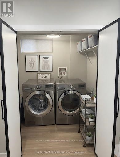 A laundry room with two front loading washing machines.