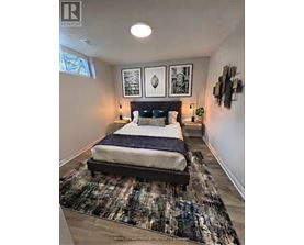 A bedroom with a large bed and a rug on the floor.