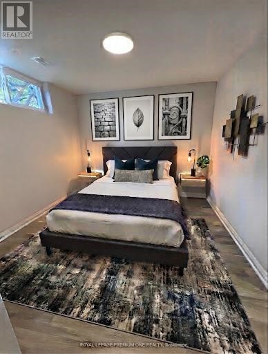 A bedroom with a large bed and a rug on the floor.
