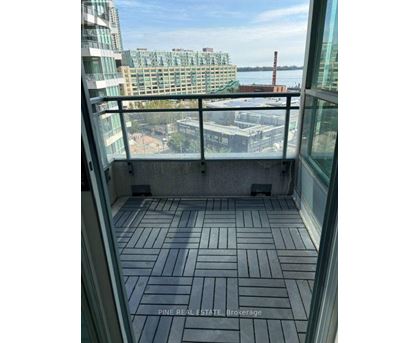 A balcony with a view of the city and water.