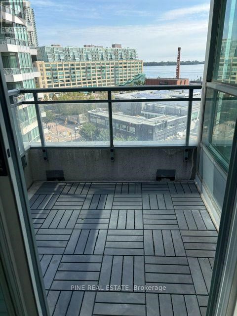 A balcony with a view of the city and water.
