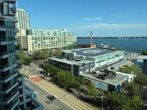 A city street with a view of the water and buildings.