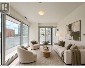 A living room with a couch, chairs, and a coffee table.