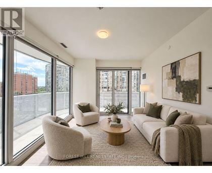 A living room with a couch, chairs, and a coffee table.
