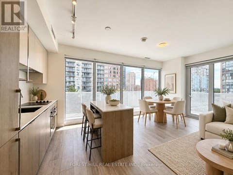 A modern kitchen with a dining table and chairs.