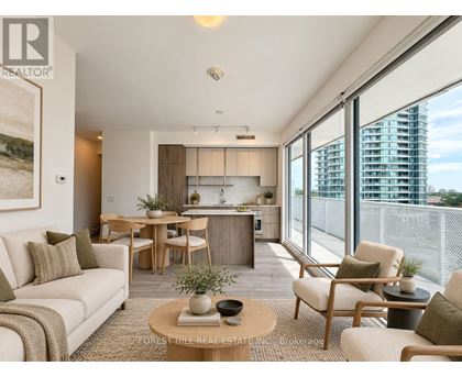 A living room with a couch, chairs, and a coffee table.