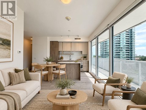 A living room with a couch, chairs, and a coffee table.
