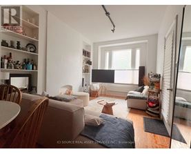 A living room with a couch, a chair, and a table.