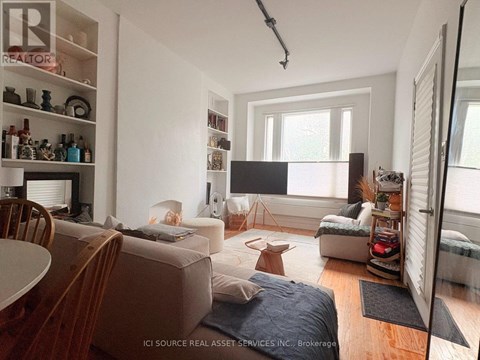 A living room with a couch, a chair, and a table.