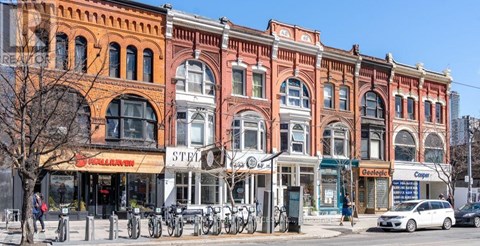A row of old buildings with a bicycle parked in front of them.