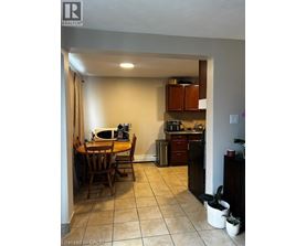A kitchen with a table and chairs in it.