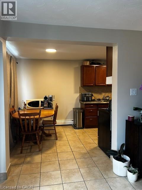 A kitchen with a table and chairs in it.
