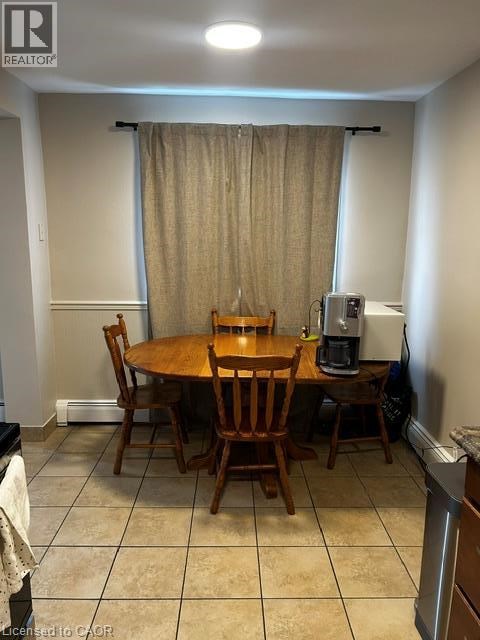 A dining room with a table and chairs.