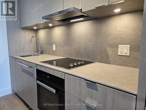 A modern kitchen with a stainless steel oven and a granite countertop.
