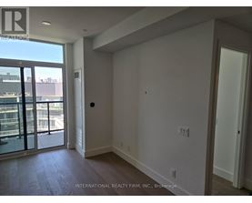 A room with a sliding glass door leading to a balcony.