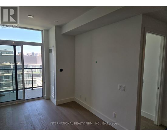 A room with a sliding glass door leading to a balcony.