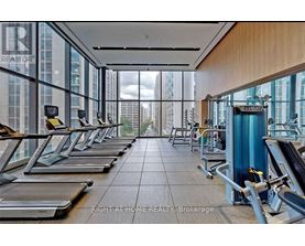 A gym with treadmills and a view of the city.