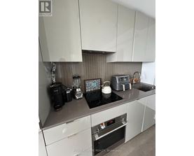 A kitchen with a stove top oven and a toaster.