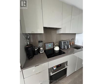 A kitchen with a stove top oven and a toaster.