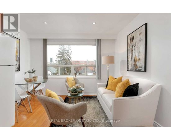 A living room with a white couch and a glass table.
