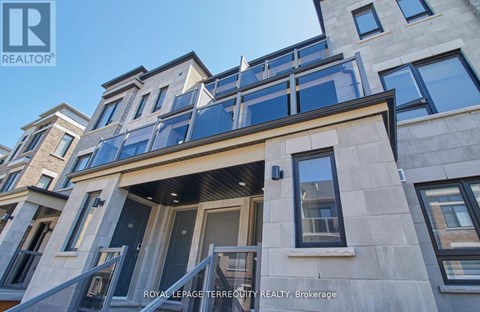 A building with a balcony and a glass door is shown.