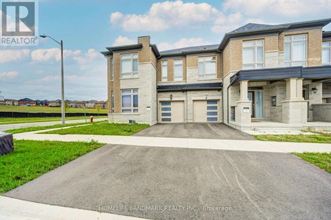 A large, modern two-story house with a driveway in front.