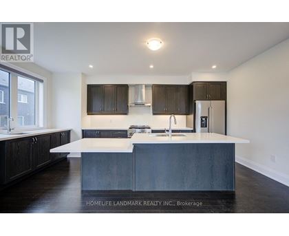 A modern kitchen with dark wood cabinets and a white island.