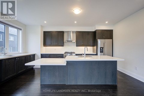 A modern kitchen with dark wood cabinets and a white island.