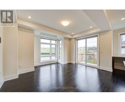 A spacious room with a sliding glass door leading to a balcony.