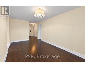 A room with wooden floors and a chandelier.