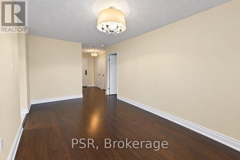 A room with wooden floors and a chandelier.