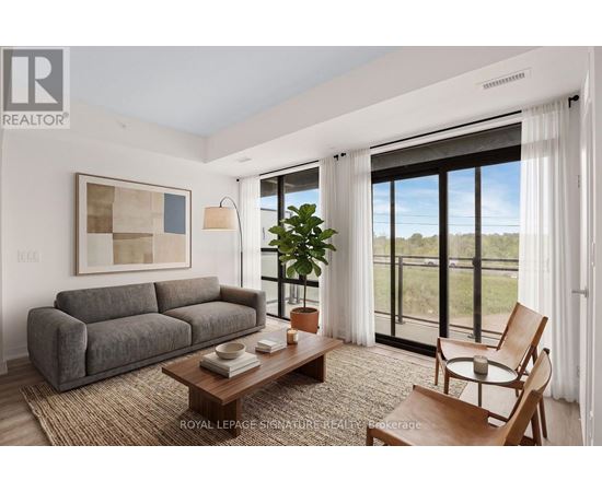 A living room with a grey couch, a wooden coffee table, and a painting on the wall.