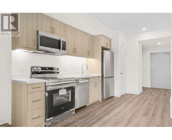 A kitchen with wooden cabinets and stainless steel appliances.