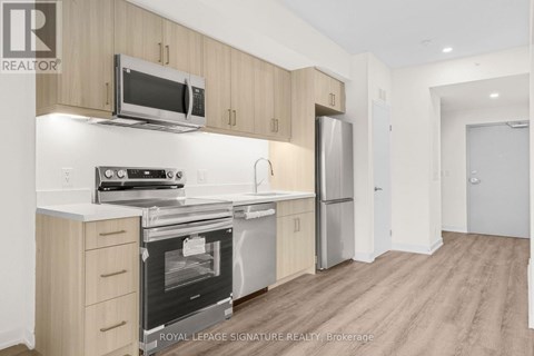 A kitchen with wooden cabinets and stainless steel appliances.