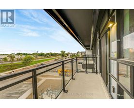A balcony with a view of a highway and trees.