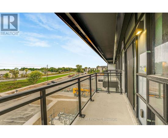 A balcony with a view of a highway and trees.