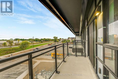 A balcony with a view of a highway and trees.