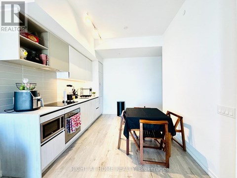 A kitchen with a table and chairs in the middle of the room.